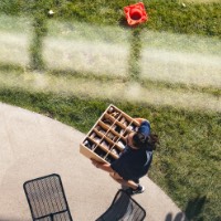 Birds Eye view of GVSU Alumna carrying box inside dorm